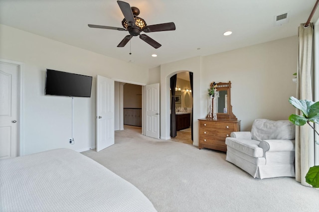 carpeted bedroom featuring connected bathroom and ceiling fan