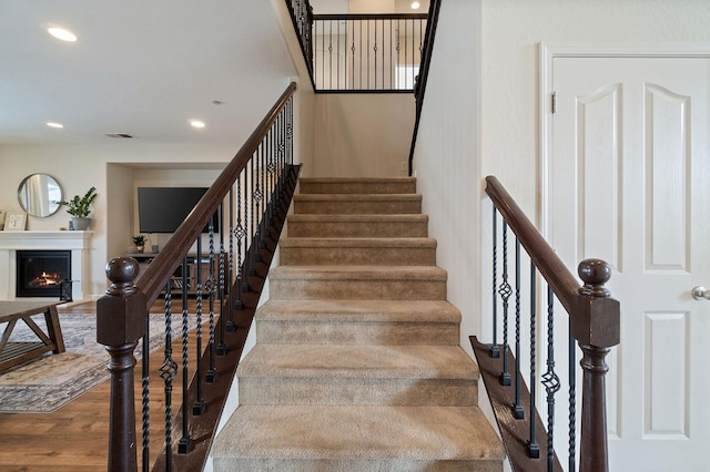 staircase featuring hardwood / wood-style flooring