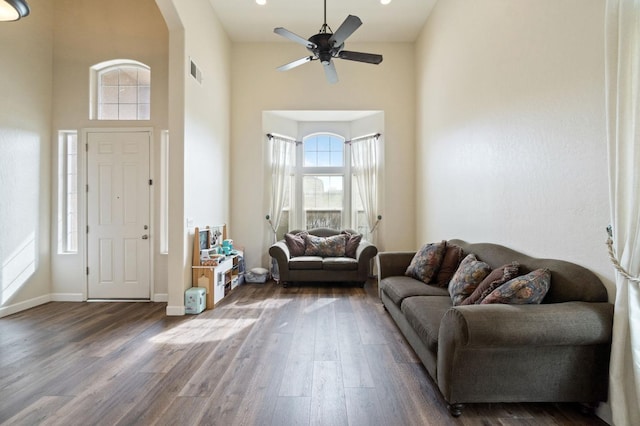 entryway featuring dark wood-type flooring, ceiling fan, and a high ceiling