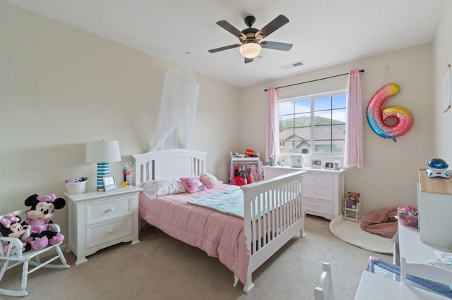 bedroom featuring light carpet and ceiling fan