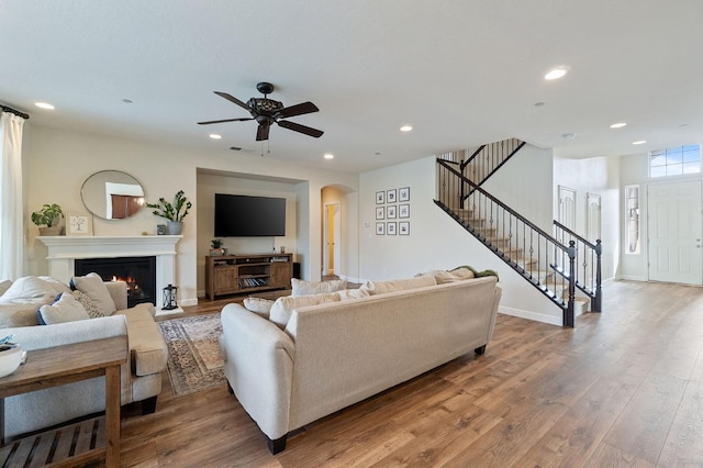 living room featuring ceiling fan and hardwood / wood-style floors