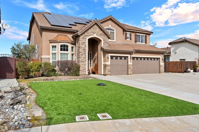 view of front of house featuring a garage, a front yard, and solar panels