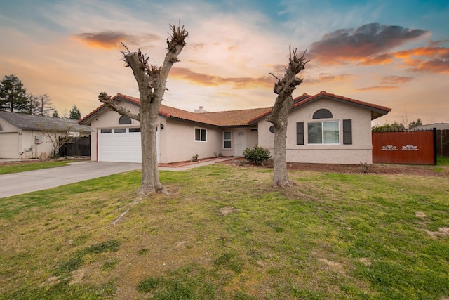 view of front of home with an attached garage, driveway, and a front yard