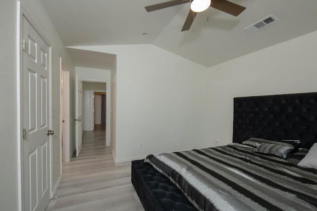 bedroom with light wood-style flooring, baseboards, visible vents, ceiling fan, and vaulted ceiling