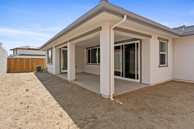 back of property featuring central AC unit and a patio area