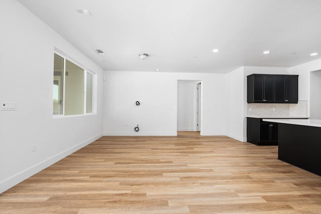 unfurnished living room with light wood-type flooring