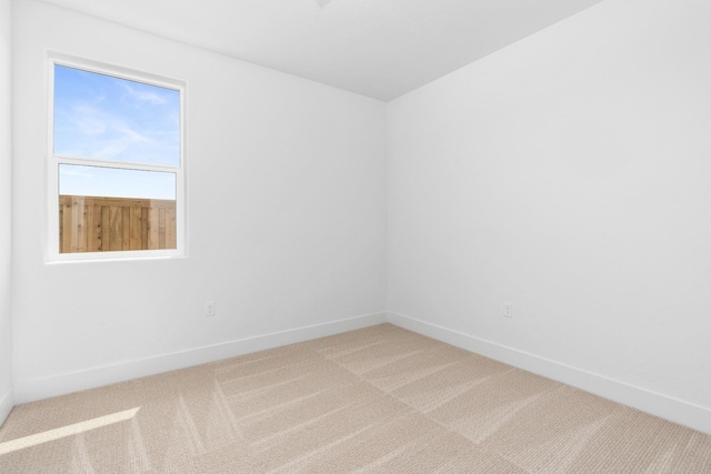 empty room featuring light carpet