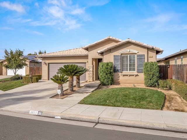 view of front of home with a garage and a front yard