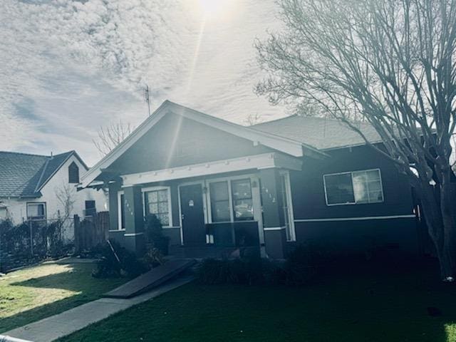 bungalow-style house with a porch and a front yard