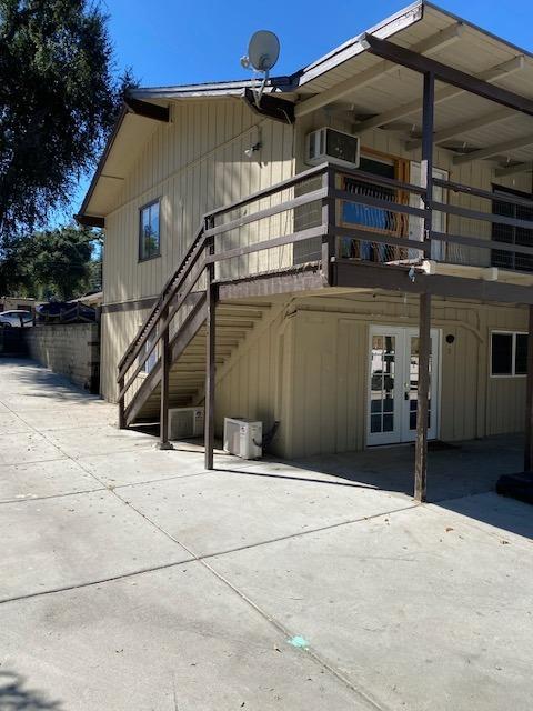 view of property exterior featuring french doors, a patio, and ac unit