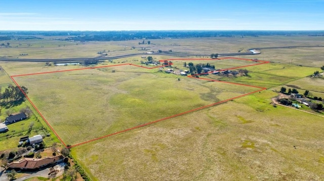 birds eye view of property featuring a rural view