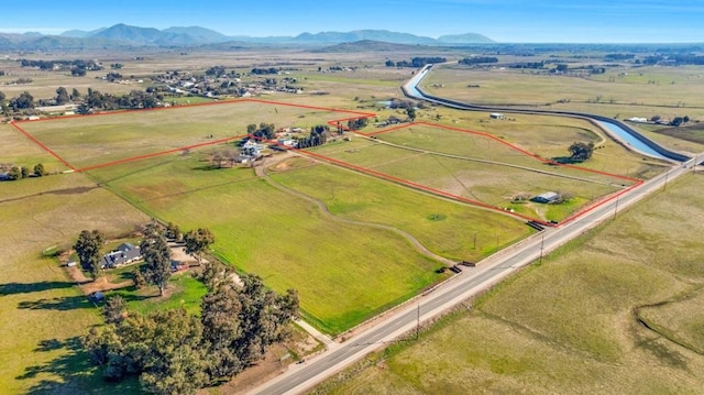 birds eye view of property with a rural view and a mountain view