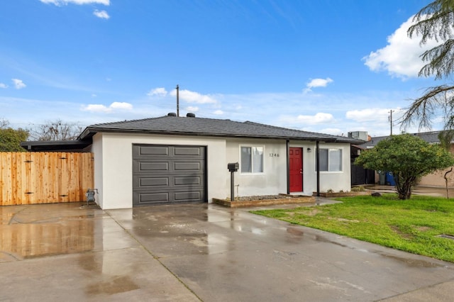 ranch-style house featuring a garage and a front yard