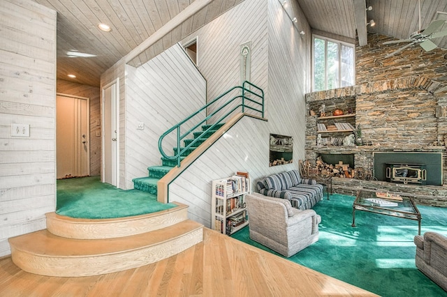 interior space with high vaulted ceiling, wooden walls, and wood ceiling