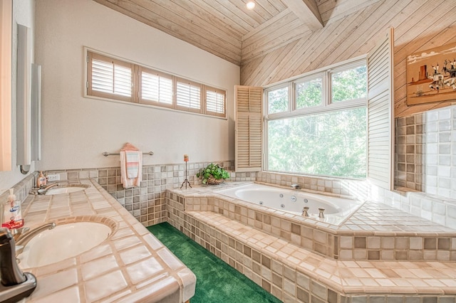 bathroom with wooden ceiling, vanity, tiled bath, and a wealth of natural light