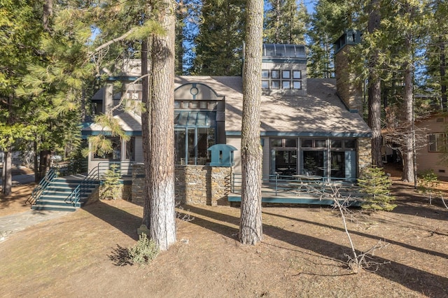 rear view of property featuring a sunroom