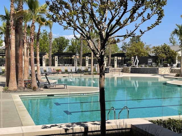 pool featuring a patio area and fence