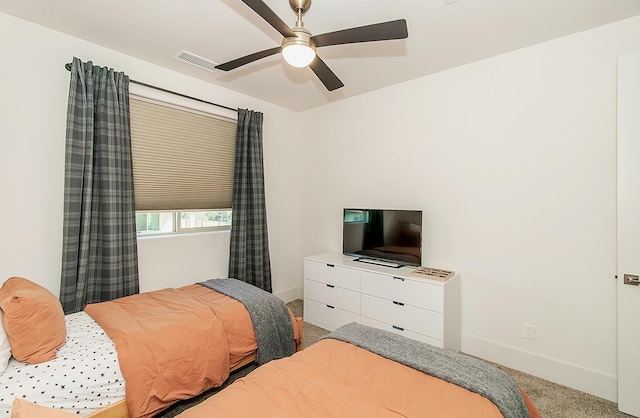 bedroom featuring visible vents, light colored carpet, and baseboards