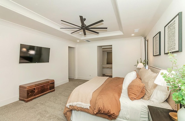 bedroom featuring a raised ceiling, connected bathroom, carpet, crown molding, and baseboards