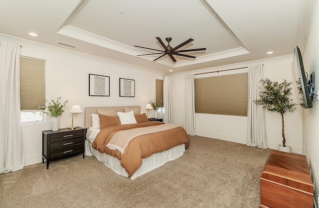 bedroom with a ceiling fan, visible vents, a tray ceiling, recessed lighting, and light colored carpet