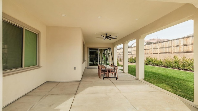 view of patio featuring fence and ceiling fan