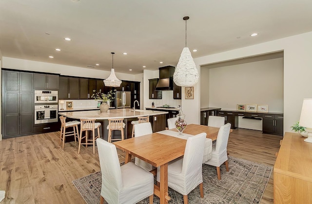 dining area with recessed lighting and light wood-style floors