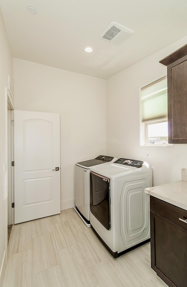 laundry area featuring visible vents, washing machine and dryer, and laundry area