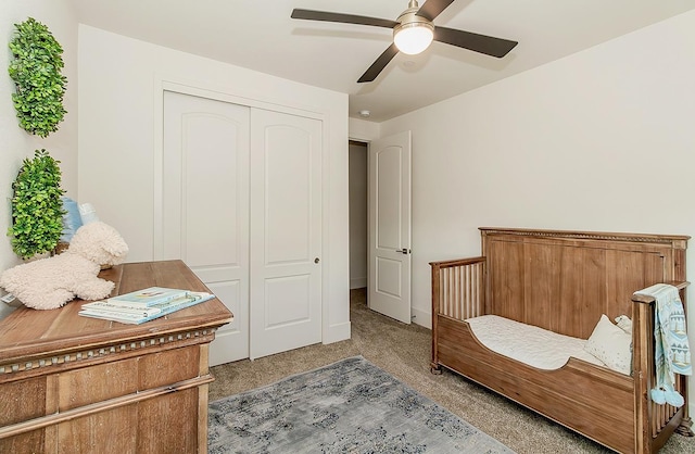 carpeted bedroom featuring a closet and a ceiling fan