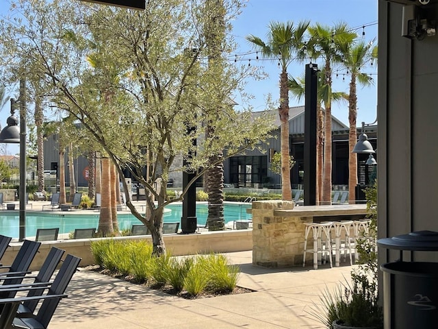 pool with a patio and outdoor dry bar