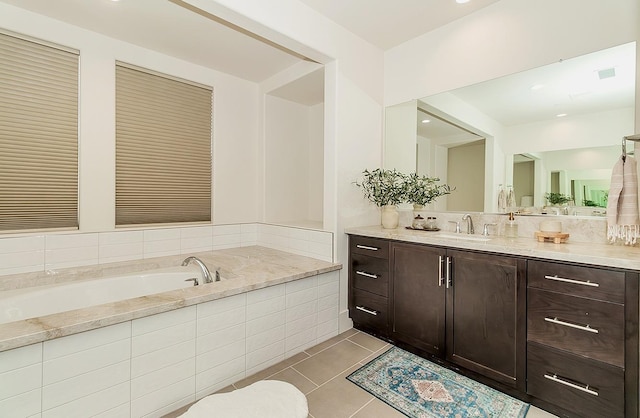 full bathroom featuring tile patterned floors, a bath, and vanity