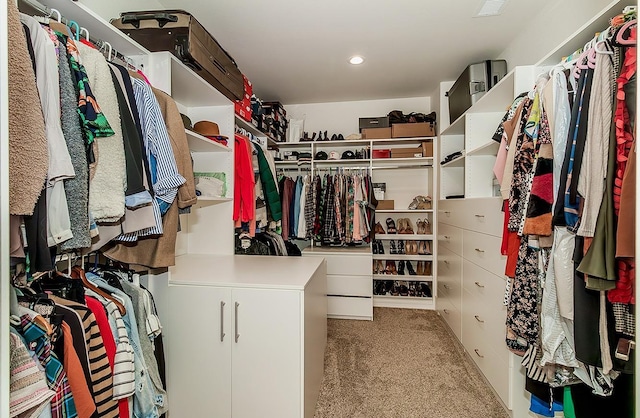 walk in closet with carpet flooring