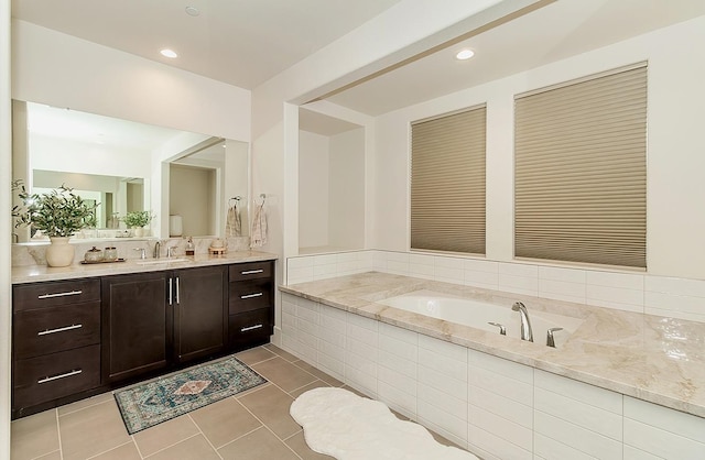 bathroom with tile patterned floors, recessed lighting, a bath, and vanity