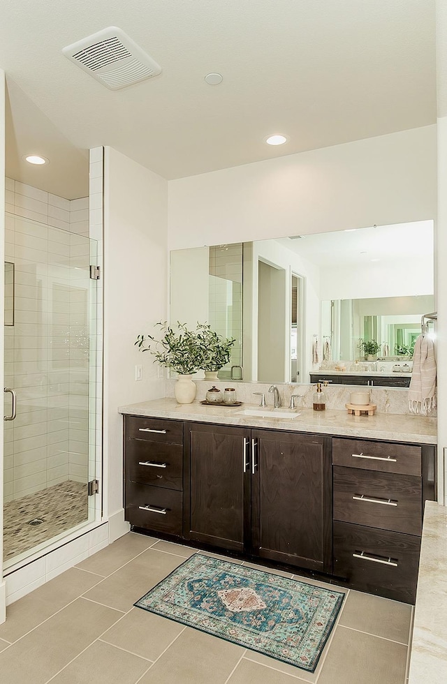 full bathroom featuring vanity, visible vents, recessed lighting, tile patterned flooring, and a shower stall