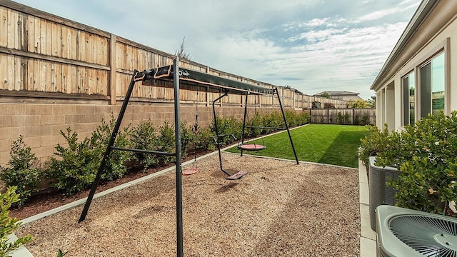 view of yard with central AC and a fenced backyard