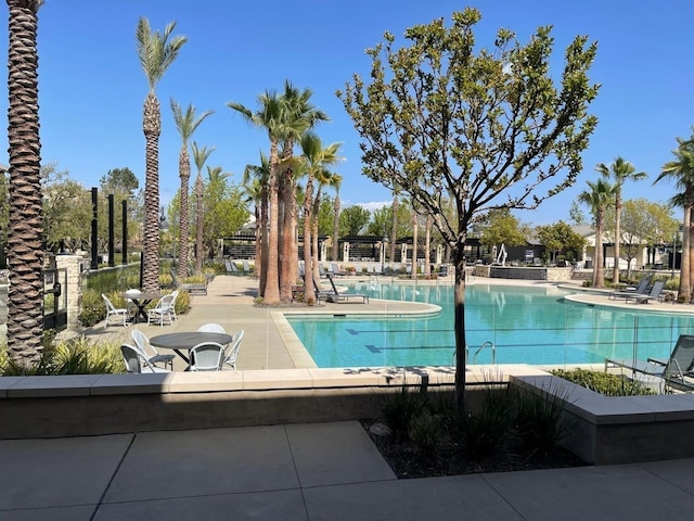 pool featuring a patio and fence