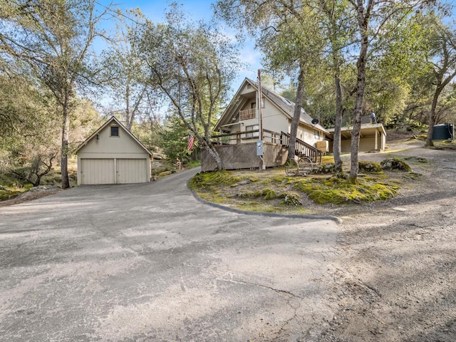 view of front of property featuring a garage and an outdoor structure