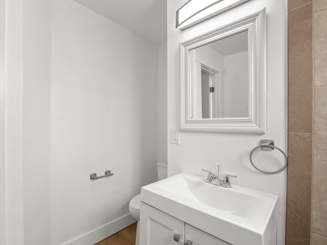 bathroom with vanity, hardwood / wood-style floors, and toilet