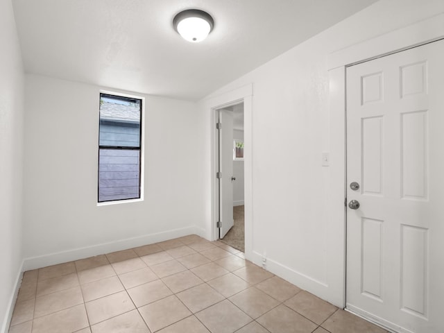 unfurnished room with light tile patterned floors