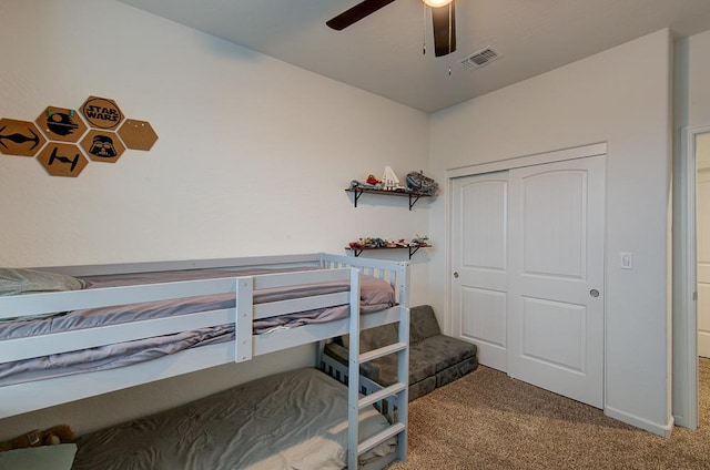 bedroom with a closet, ceiling fan, and carpet