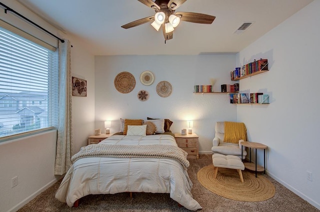 bedroom featuring multiple windows, ceiling fan, and carpet