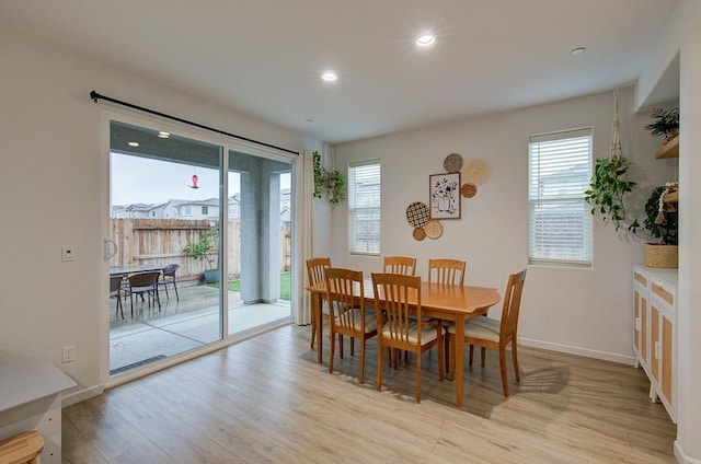 dining area with plenty of natural light and light wood-type flooring