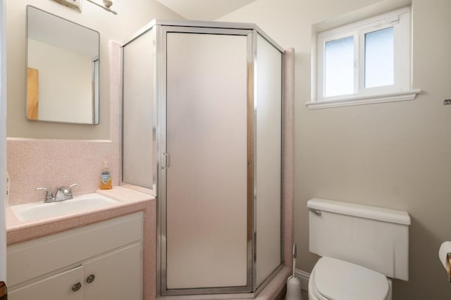 bathroom with walk in shower, vanity, toilet, and tasteful backsplash