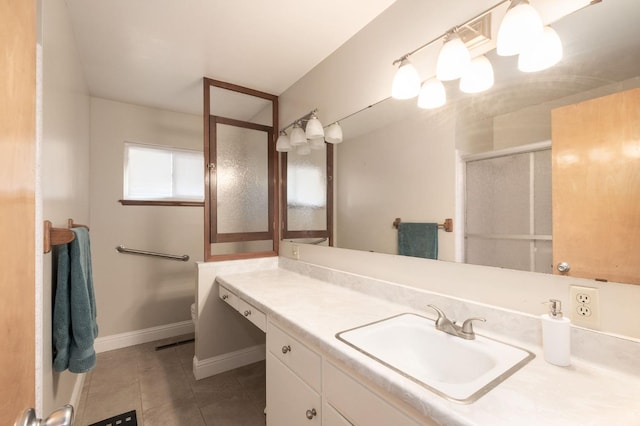 bathroom featuring tile patterned floors, vanity, and a shower with shower door