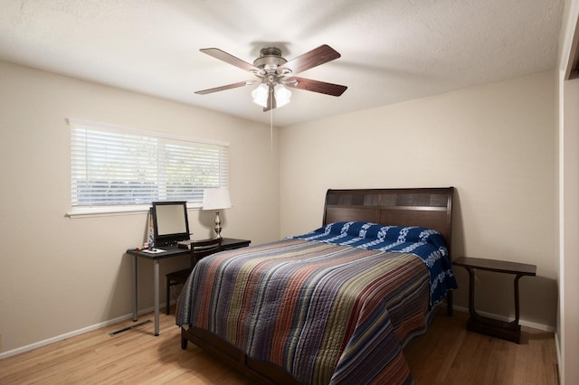 bedroom featuring light hardwood / wood-style flooring and ceiling fan