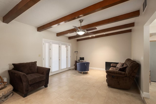 sitting room with beamed ceiling and ceiling fan