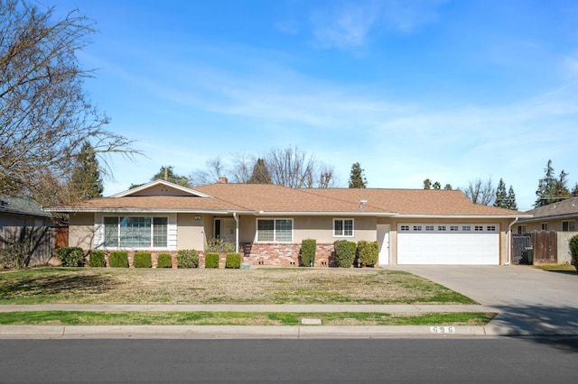 696 W Celeste Ave, Fresno, CA 93704 - ranch-style house featuring an attached garage, driveway, stucco siding, and brick siding