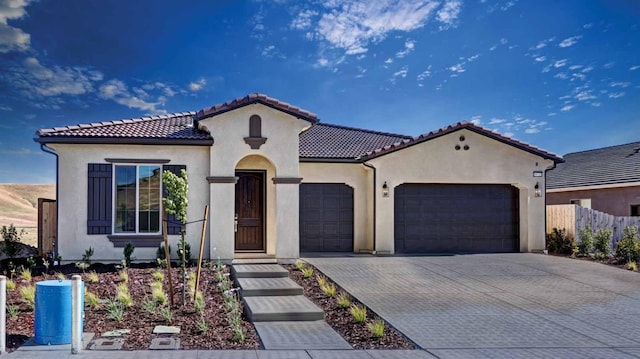 mediterranean / spanish-style home with a garage