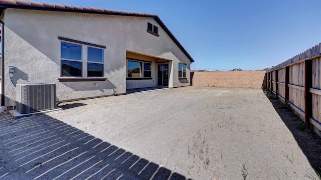 rear view of property featuring a patio and central AC unit