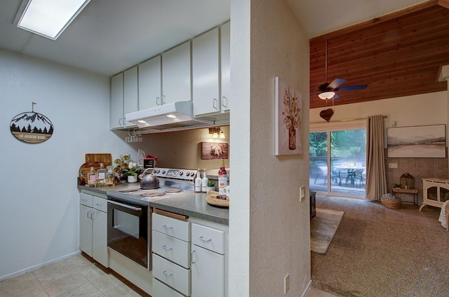kitchen featuring electric stove, white cabinetry, lofted ceiling, and ceiling fan