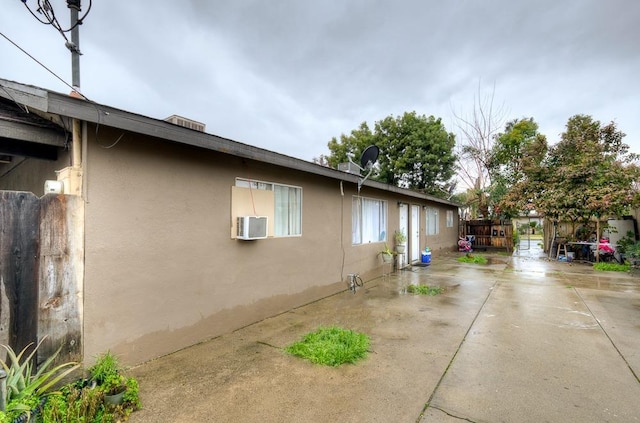 view of side of home featuring a patio area and stucco siding